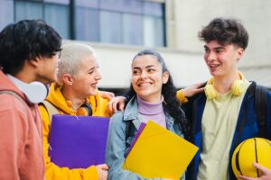 Young students laughing at the university building