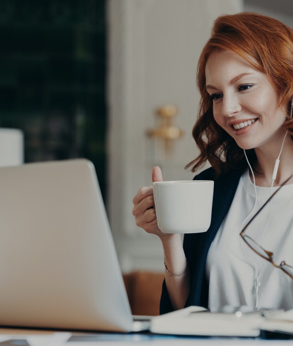 Intelligent female student has online course, concentrated in screen of laptop computer